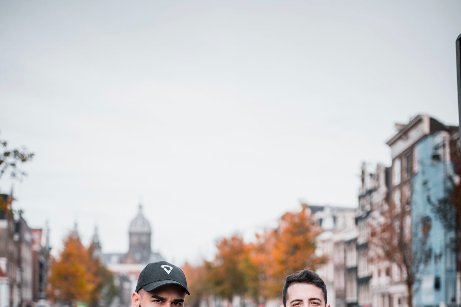 Two DJs walking an Amsterdam street in autumn during ADE
