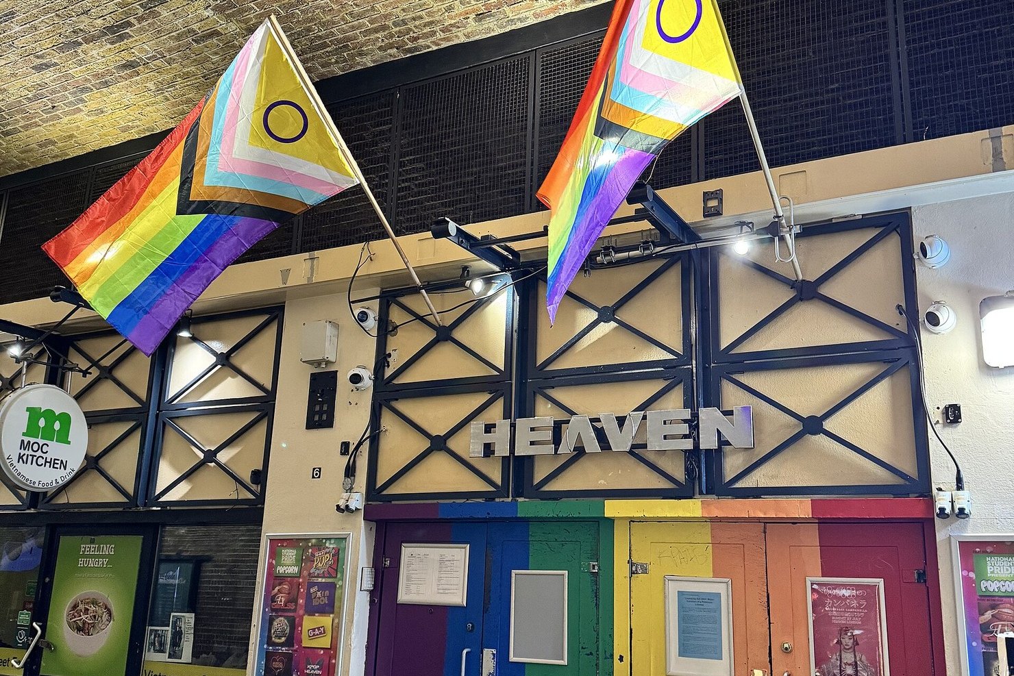 The entrance to Heaven nightclub in London while closed, rainbow-painted doors shut under Pride flags and the HEAVEN sign