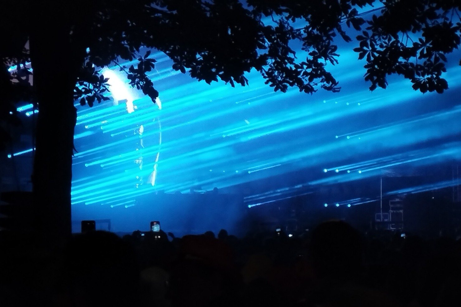 Charlotte de Witte's stage lit by a wall of blue lasers cutting through trees at Rock en Seine, Paris, August 2023