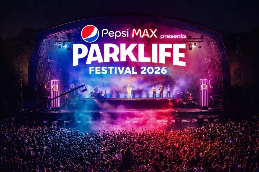 Parklife 2026 poster.  Crowd at Parklife Festival 2026 under a lit stage with performers. Vibrant lights and "Pepsi Max presents Parklife Festival 2026" text visible.