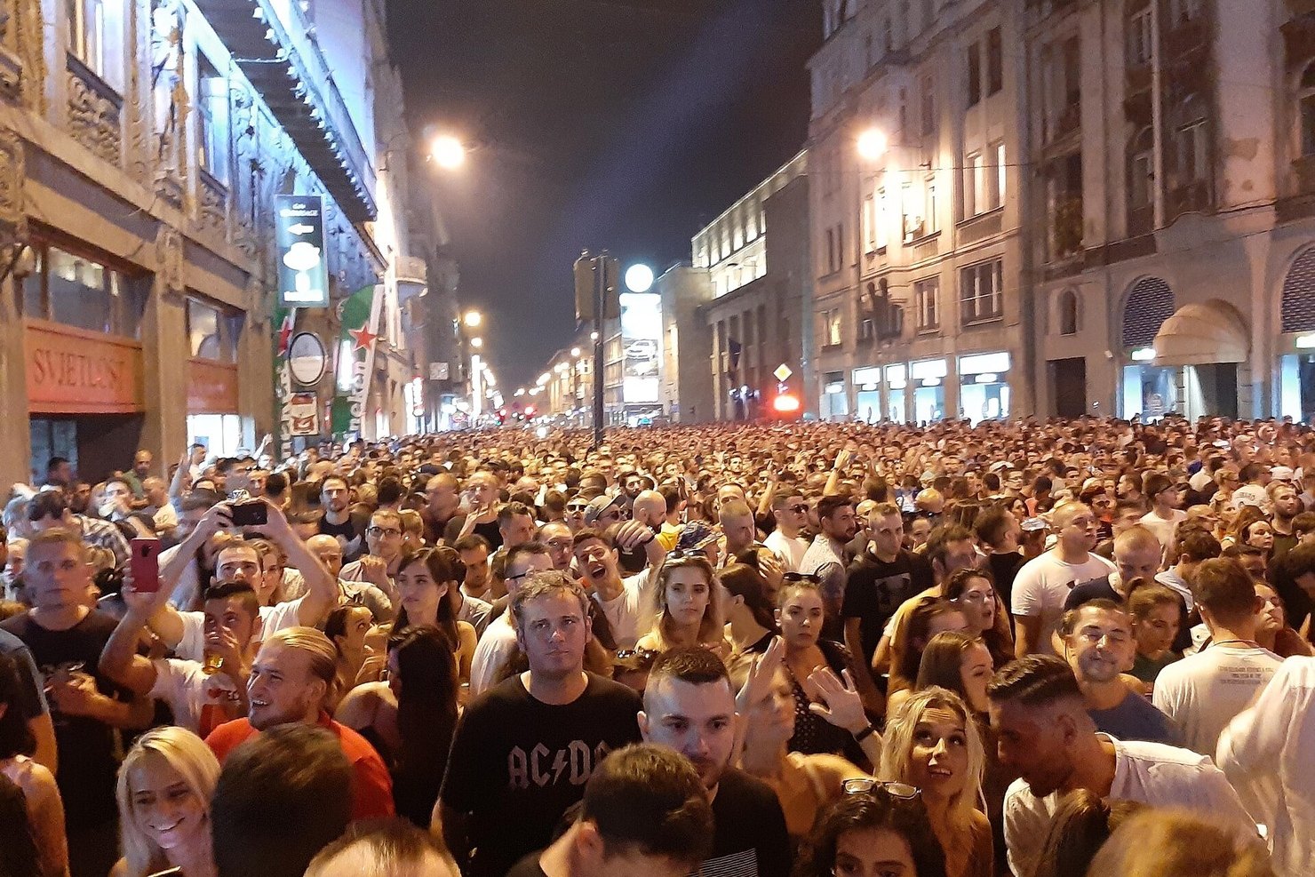 Thousands of people filling a Sarajevo street at night for Solomun's free open-air show in August 2019, phones raised and hands in the air