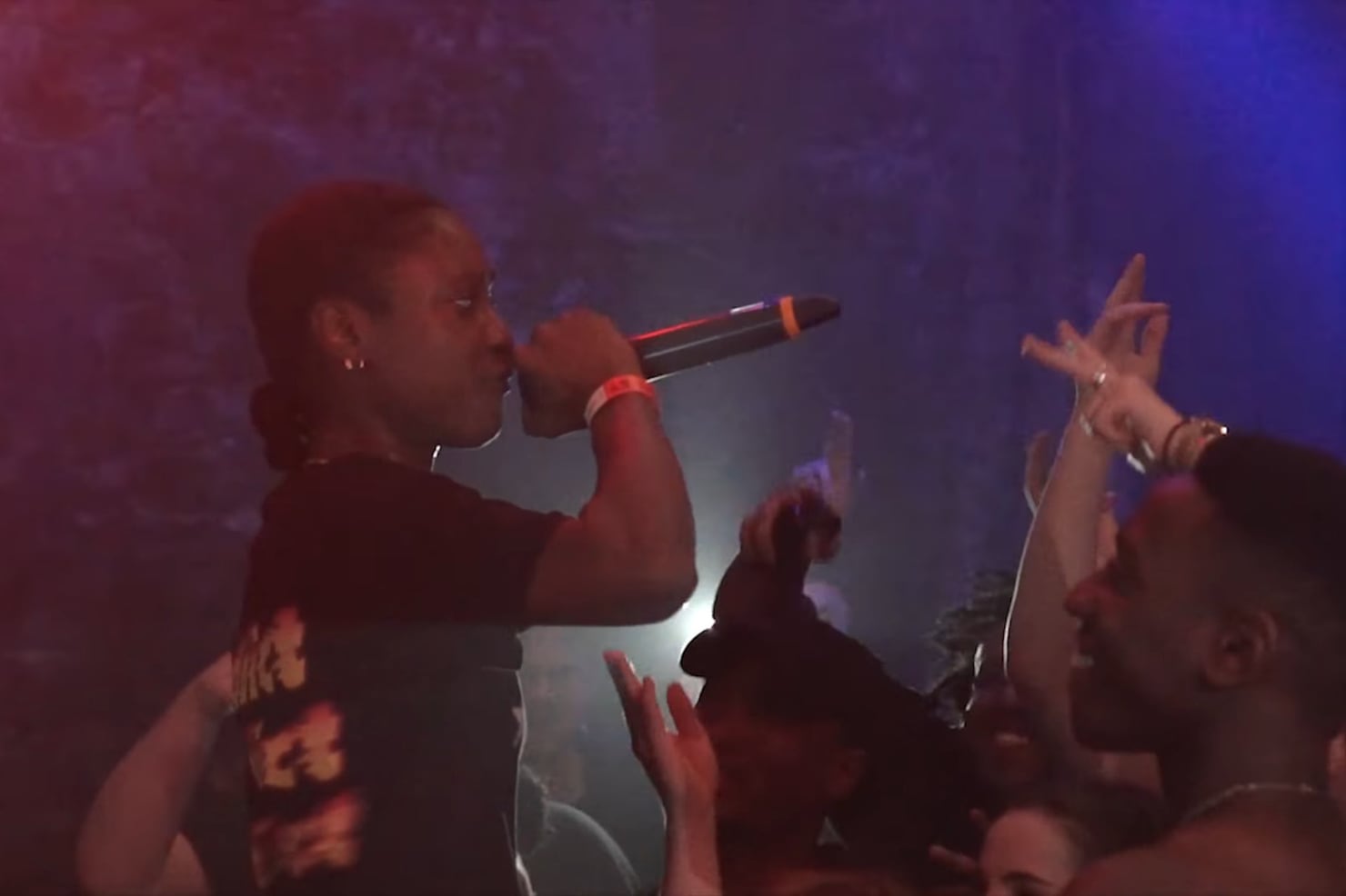 Flohio performing into a microphone at the Warehouse Project in Manchester